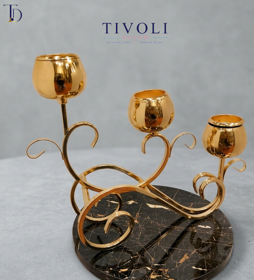 Luxury 3-cup golden tulip candelabra with a veined black marble base by Tivoli Decor, a premium table decoration piece for dining settings in Pakistan.