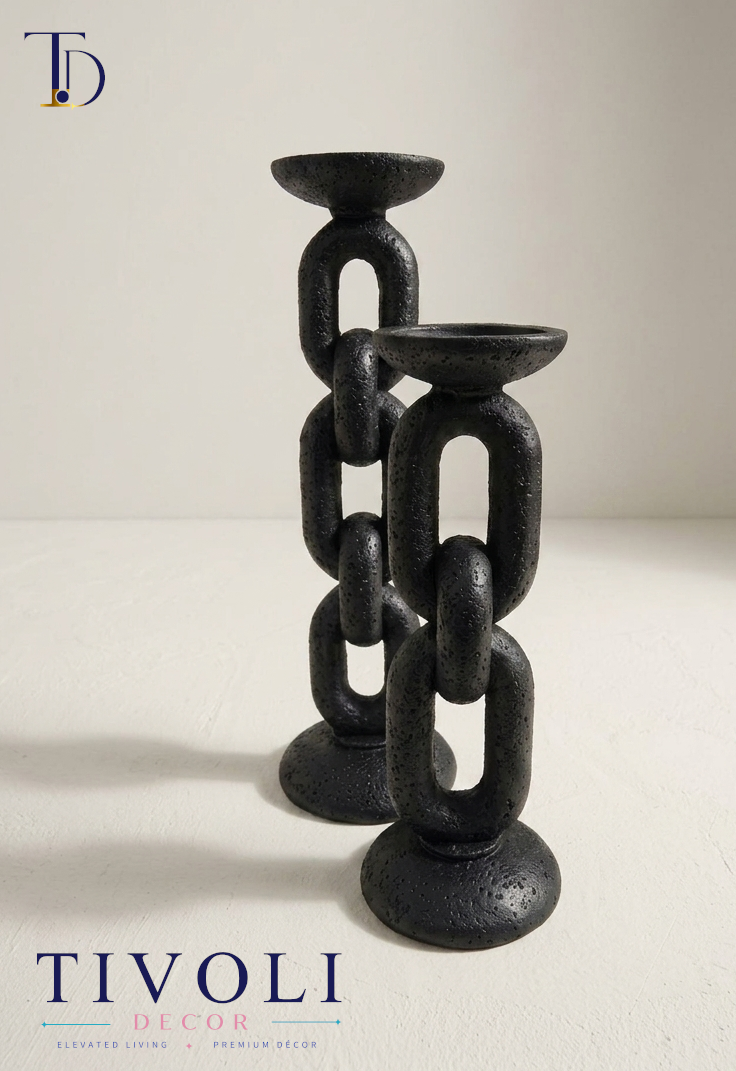 Nordic matte black chain candlestick holders by Tivoli Decor, a premium abstract decoration piece for living room mantles in Pakistan. Close-up showing the volcanic sand-textured stone patina and nested loop silhouette of the twin black ceramic chain candle holder sculpture by Tivoli Decor.