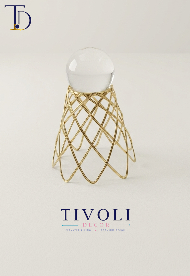 Luxury crystal ball on a geometric golden wire mesh stand by Tivoli Decor, a premium abstract decoration piece for living room tables in Pakistan.