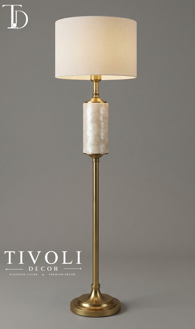 Branded Tivoli Decor luxury brushed brass floor lamp with an iridescent mother of pearl column accent and cream linen shade against a grey background.