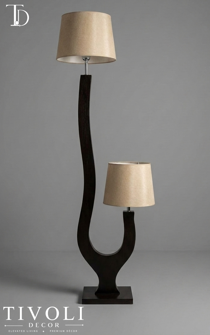 Branded Tivoli Decor duet sculptural wooden dual light floor lamp with a dark curved espresso frame and twin beige linen shades against a grey background.