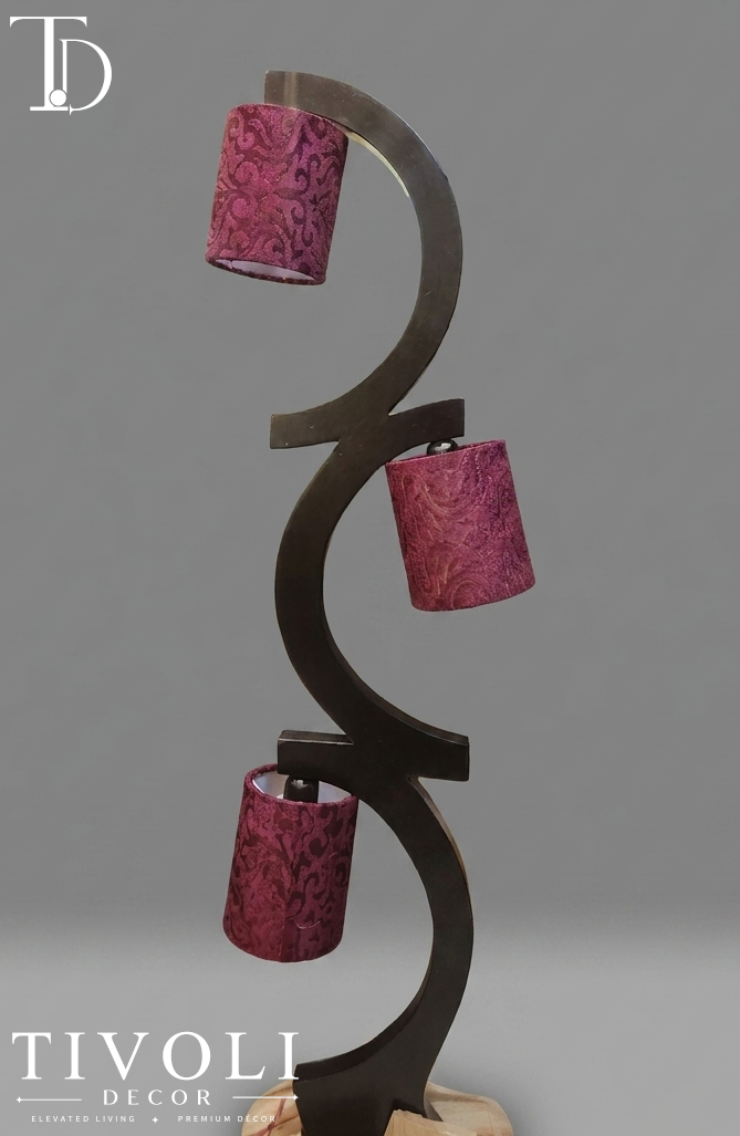 Branded Tivoli Decor trinity sculptural wooden multi light floor lamp with a dark interlocking wave frame and three maroon damask patterned fabric shades.