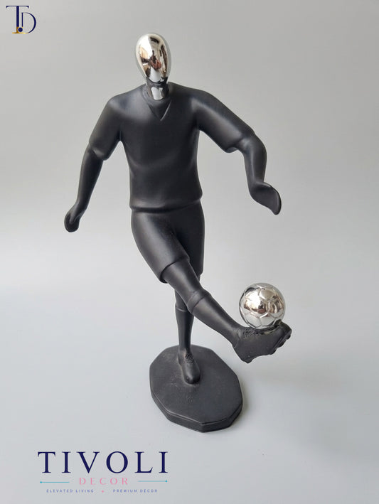 Modern matte black and chrome silver football player statue by Tivoli Decor, a premium abstract sports decoration piece for study desks in Pakistan.