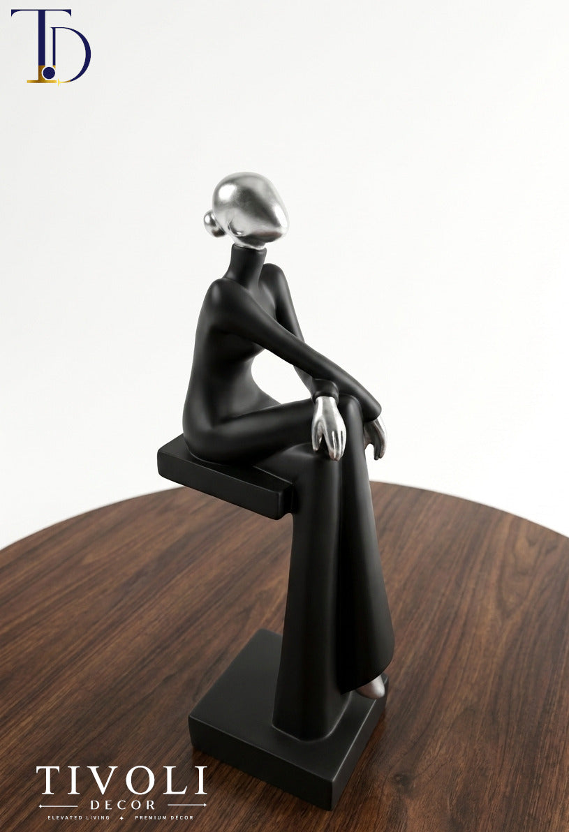 Buy the Sitting Lady Statue at Tivoli Decor. Premium modern abstract black & chrome silver female sculpture. Perfect luxury table decoration piece in Pakistan.