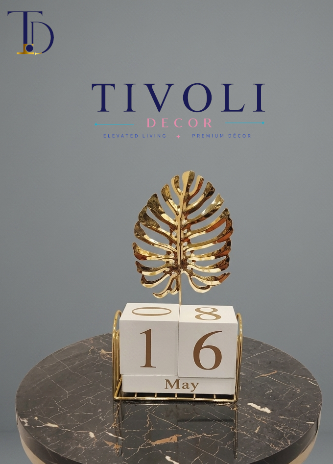 Luxury golden monstera leaf perpetual calendar by Tivoli Decor, a premium functional decoration piece for office desks in Pakistan.