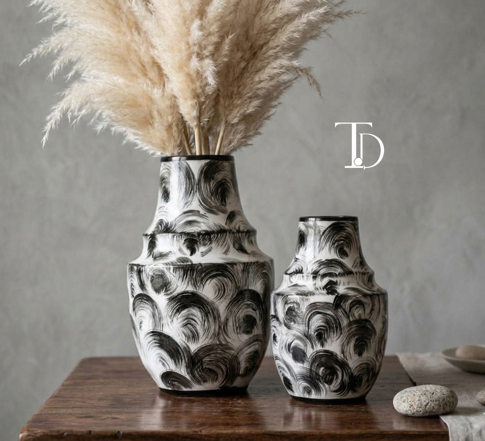 Set of two hand-painted black and white swirl ceramic vases with pampas grass
