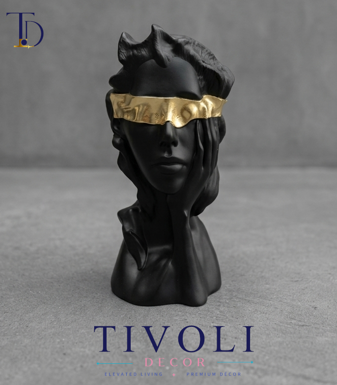 Modern matte black blindfolded lady bust statue with golden accents by Tivoli Decor, a premium abstract decoration piece for living room tables in Pakistan.
