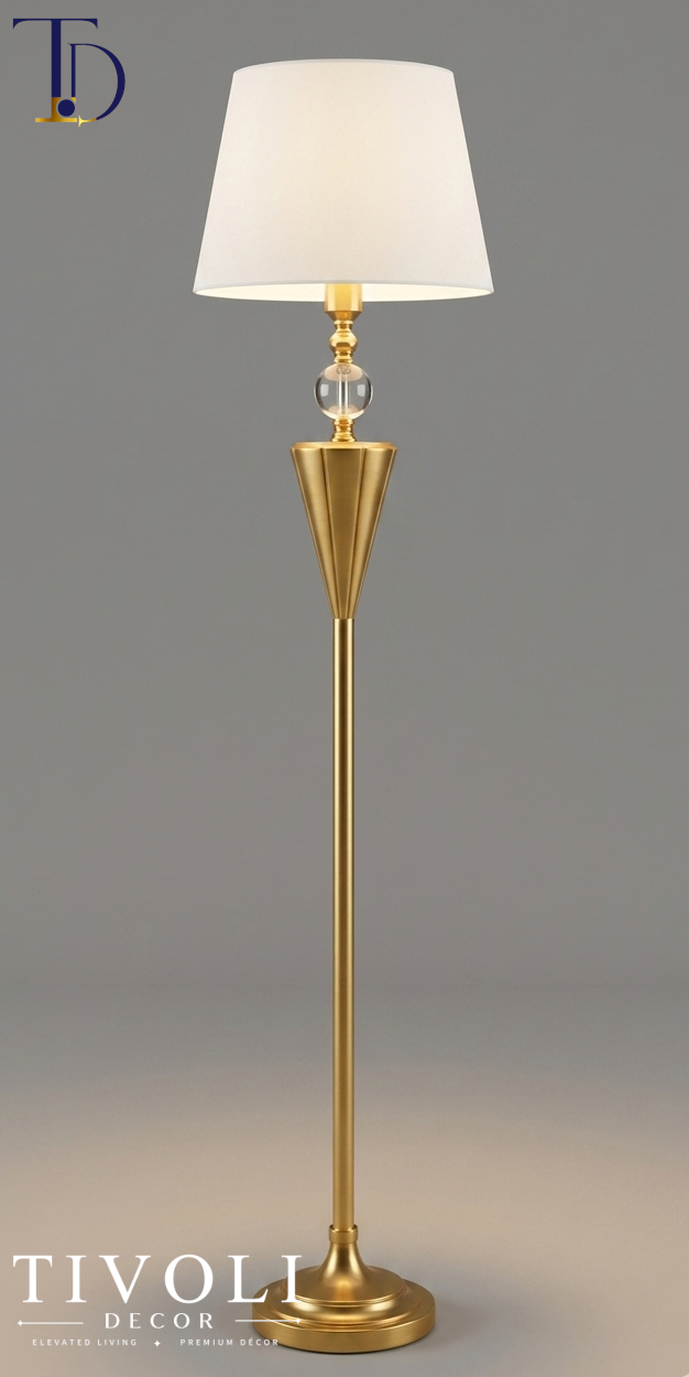 Branded Tivoli Decor luxury gilded chalice floor lamp with a fluted gold stem, clear crystal sphere accent, and tapered ivory shade against a grey background.