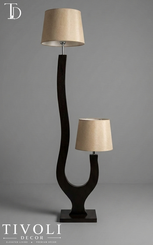 Branded Tivoli Decor duet sculptural wooden dual light floor lamp with a dark curved espresso frame and twin beige linen shades against a grey background.