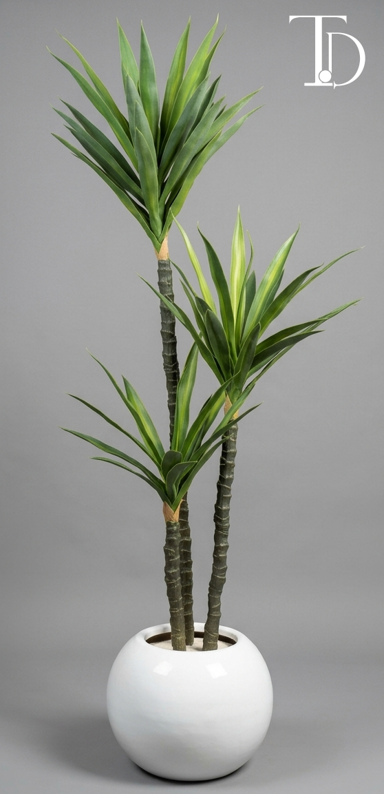 Branded Tivoli Decor luxury artificial yucca cane tree with three staggered textured stalks and sharp green sword leaves standing in a glossy white spherical orb planter.