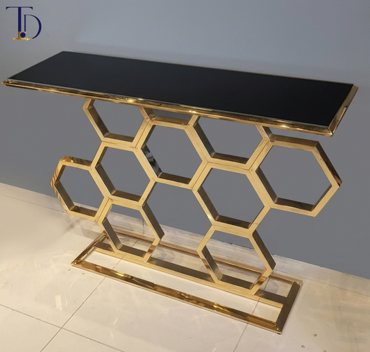 Branded Tivoli Decor luxury honeycomb console table with a sleek black glass top, interlocking gold geometric hexagon base, and stable rectangular baseline.