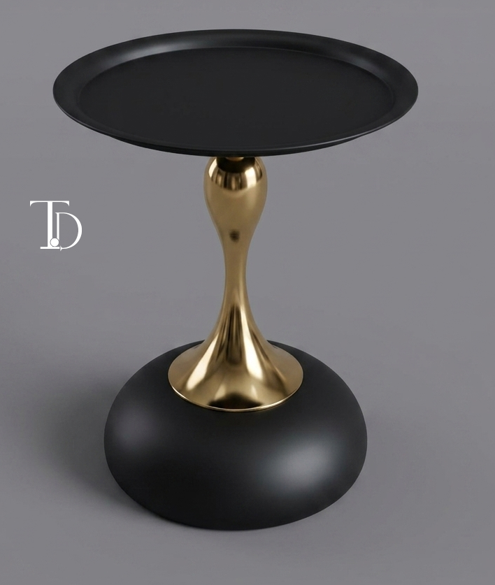 Branded Tivoli Decor luxury accent side table with a matte black tray top, polished gold hourglass stem, and a heavy matte black dome base.